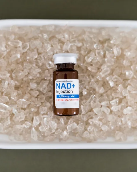 A vial of NAD+ resting on a bed of crystals