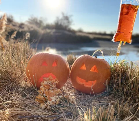 Two carved pumpkins: one looking sick, one smiling