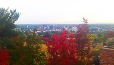 Downtown Boise from the foothills, framed by red fall trees