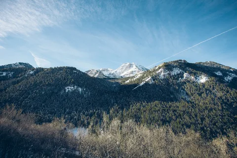 Snow-capped peaks above the forested slopes of American Fork Canyon, next to Cedar Hills