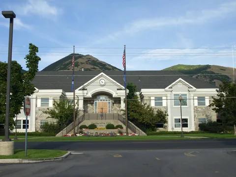 Centerville City Hall with its clock gable and the foothills behind it