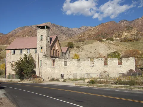 The old stone Cottonwood Paper Mill at the mouth of Big Cottonwood Canyon, under autumn mountains