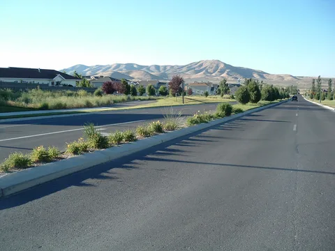 Homes along Pony Express Parkway in Eagle Mountain, with bare desert hills behind