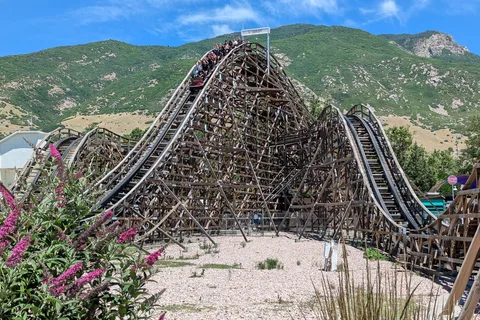 Lagoon's wooden Roller Coaster in Farmington with the green Wasatch foothills behind