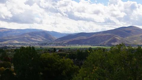 The Heber Valley and the town below the mountains under a cloudy sky