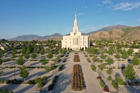 The Payson Utah Temple and its gardens from above, with the mountains behind