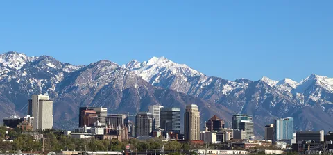 The Salt Lake City skyline under snowy mountains