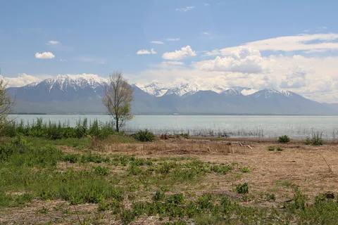 Utah Lake and the snowy Wasatch Mountains seen from the shore at Saratoga Springs