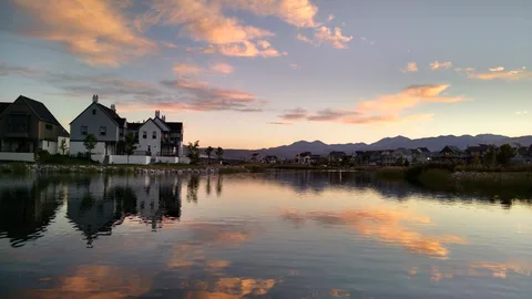Daybreak homes along Oquirrh Lake at sunset, with the Oquirrh Mountains behind