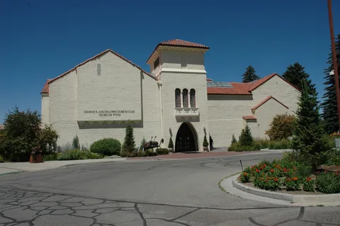 The Springville Museum of Art, a white Spanish-style building with a red tile roof, under a blue sky