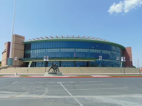 The glass front of the Maverik Center arena in West Valley City, with its hockey-player statue