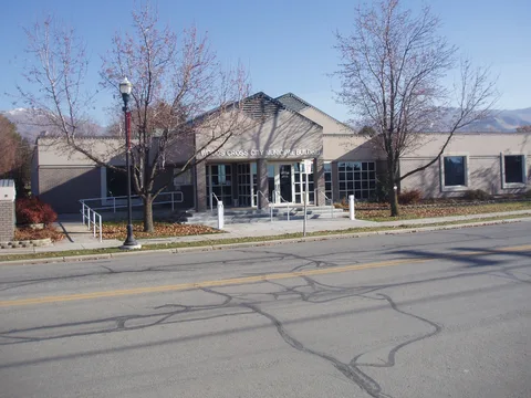 Woods Cross City Municipal Building with bare autumn trees and the mountains behind