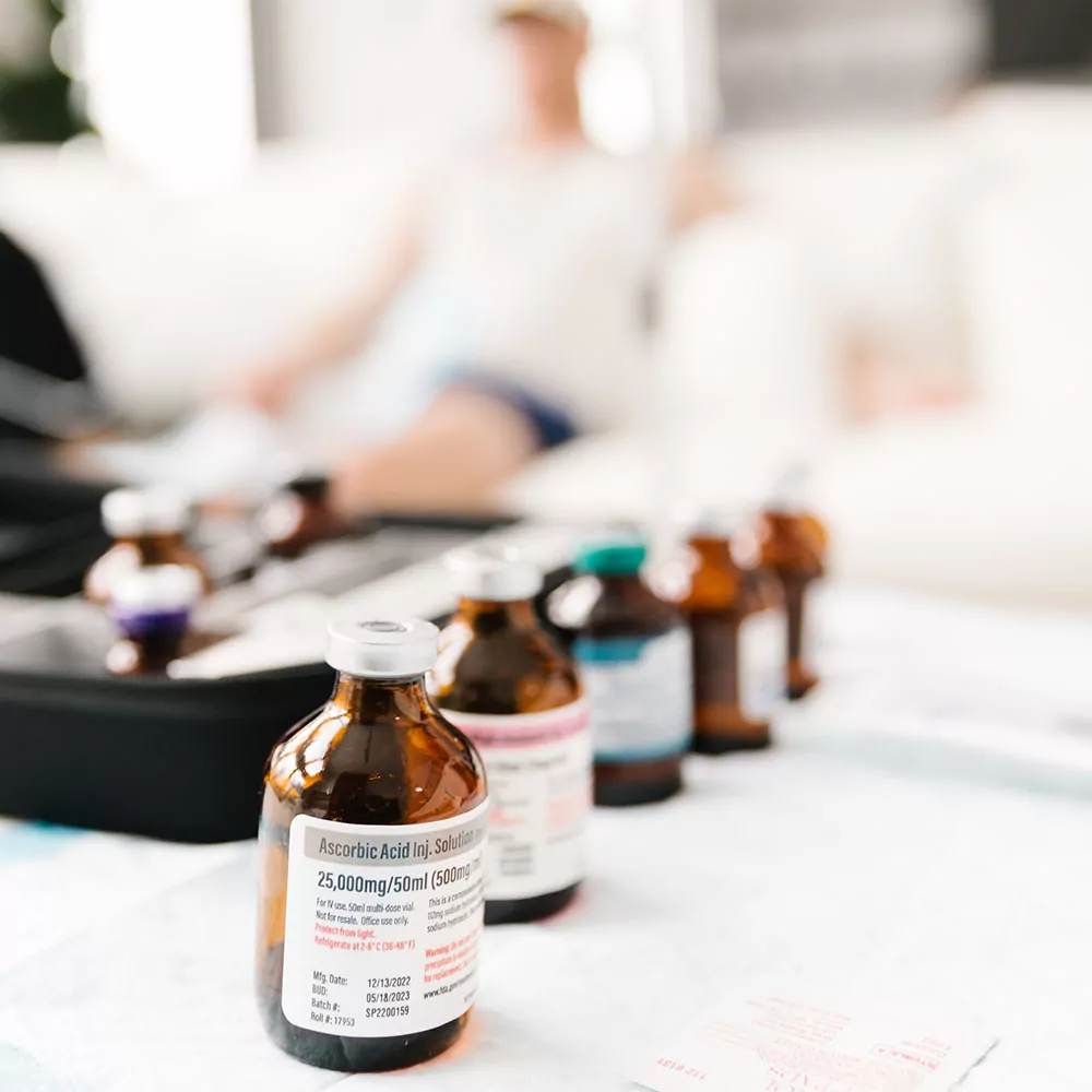 A line up of vitamin bottles ready to be put in an iv bag