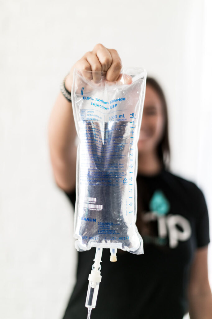 Nurse in the background holding up IV bag