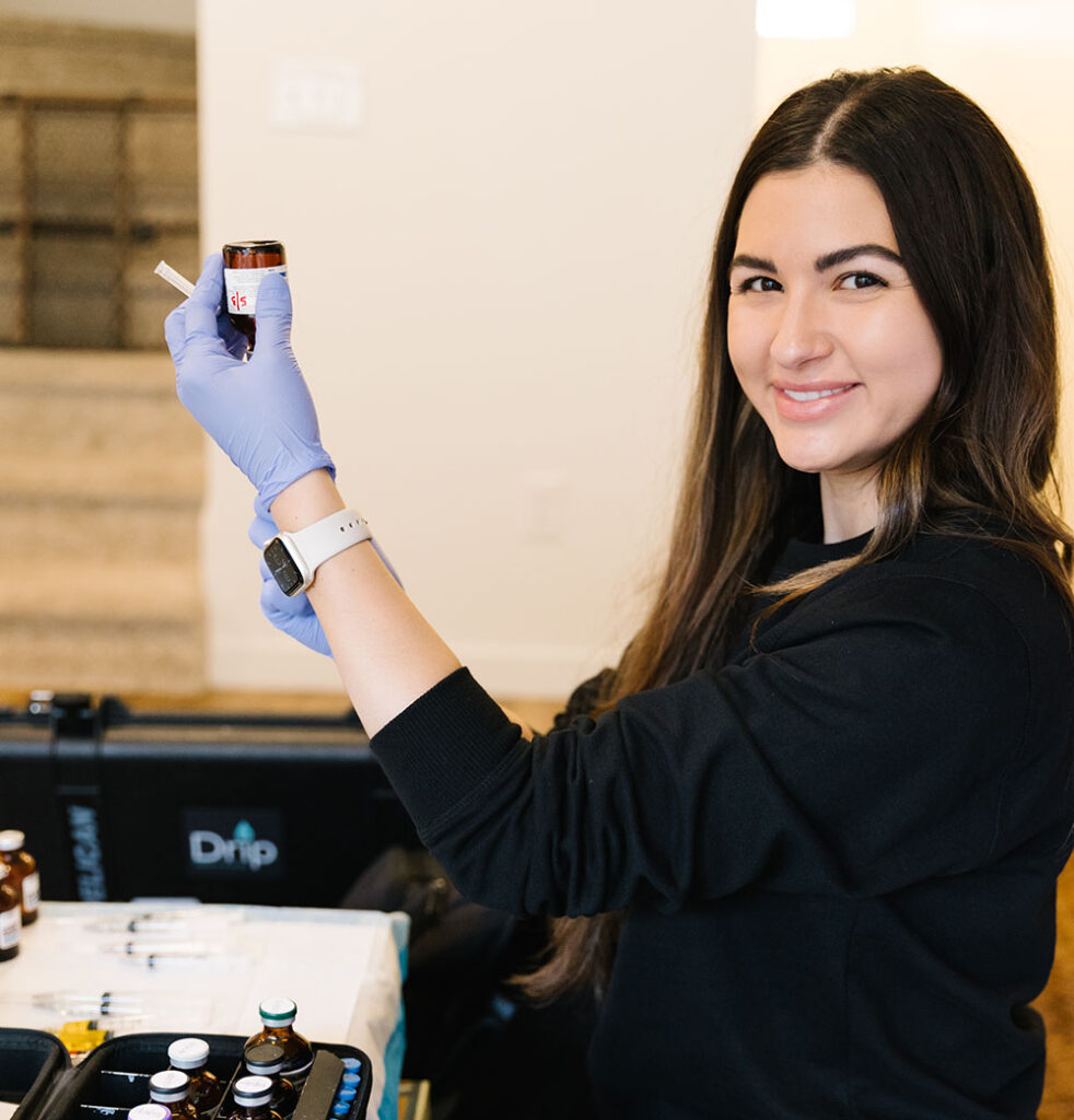 Nurse Jessica Prepping a Biotin injection as part of a Concierge IV Service smiling at the camera