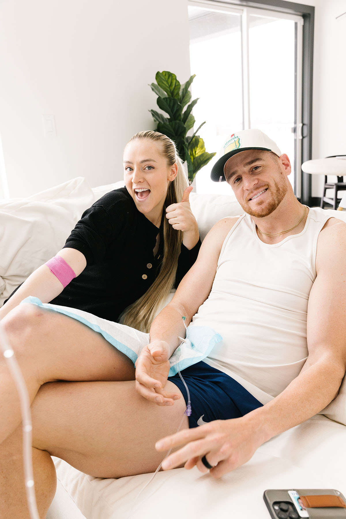 Smiling couple getting IV therapy at home