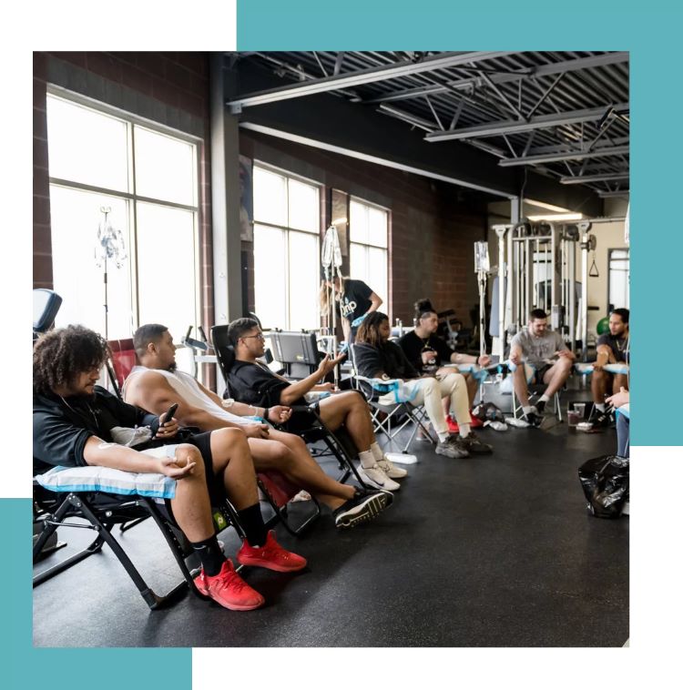 A group of men at the gym getting mobile iv treatments together