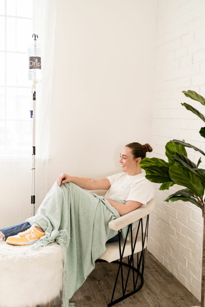 Woman getting iv hydration in taylorsville while sitting in a cozy chair with a blanket