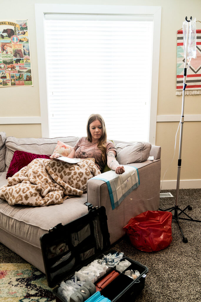 Woman getting iv therapy in vineyard on a cozy couch