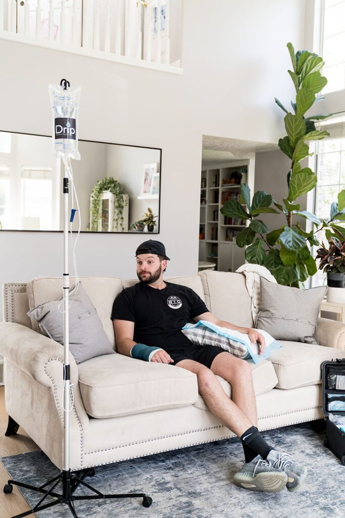 man sitting on couch getting an IV