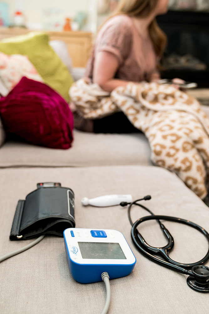 Equipment to Prep for IV Oxygen Therapy in Utah on a couch. Equipment includes blood pressure gage, thermometer, and stethoscope