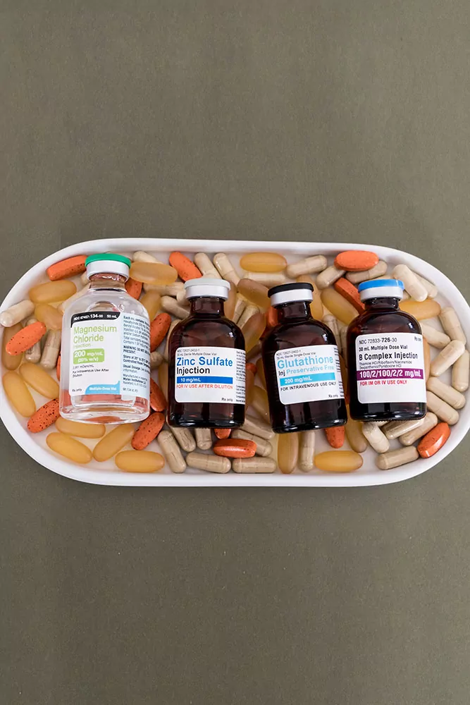 Vitamin Bar Vials Lined Up showing Myers cocktail ingredients on a tray of oral vitamin supplements