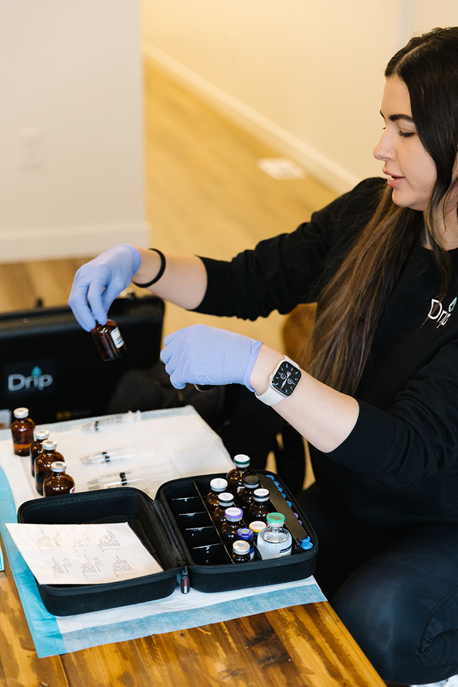 Nurse prepping drip hydration in layton, ut by organizing vials and prepping syringes