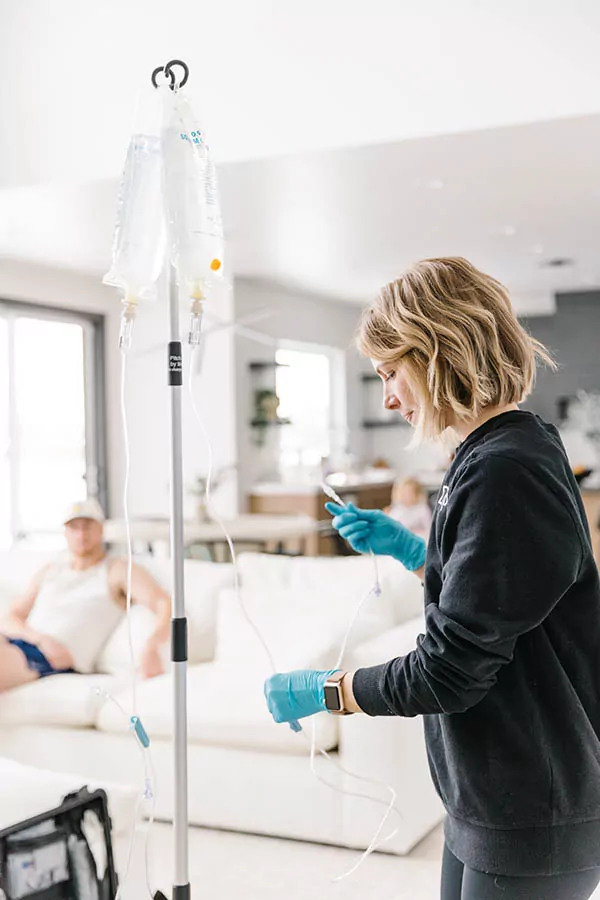 nurse preparing IV therapy and explaining what to expect from NAD before and after