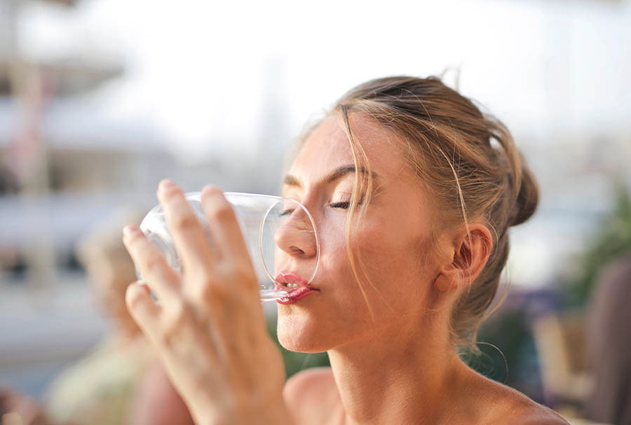 Woman drinking water with liquid iv energy