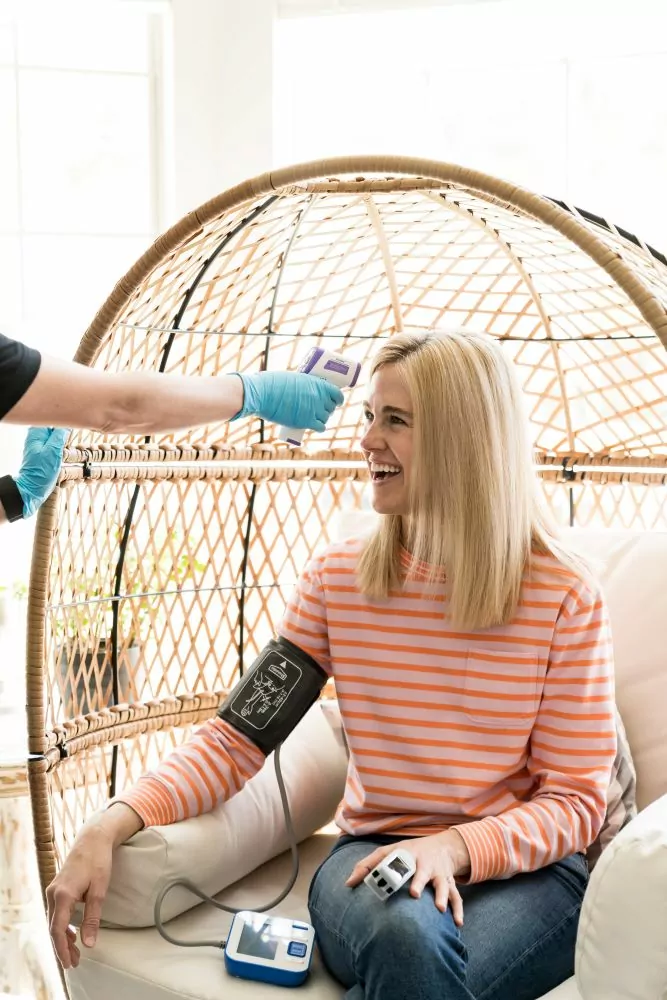 Woman in a basket chair getting a mobile iv American Fork